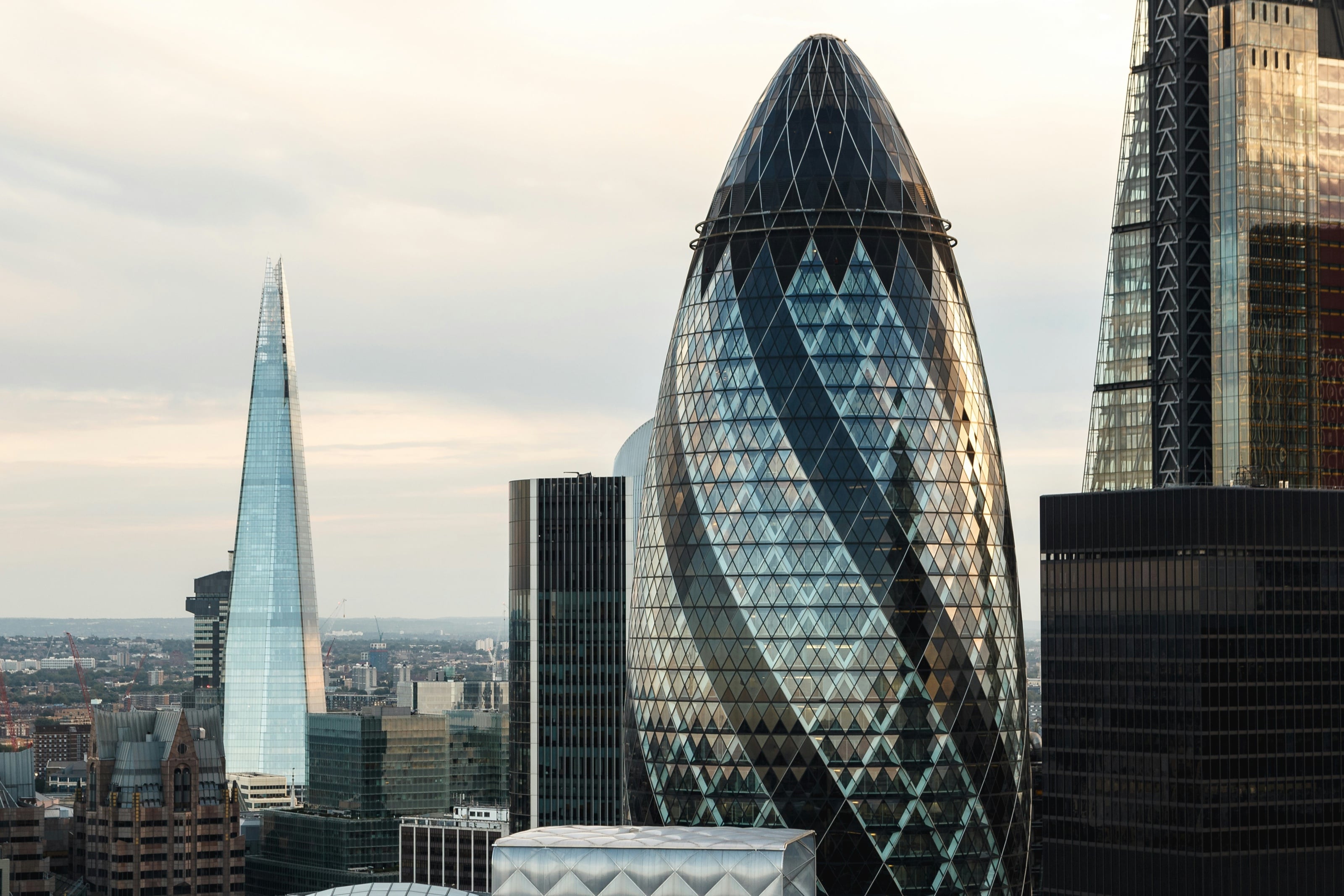 Glass facades of the Gherkin and the Shard in the City of London